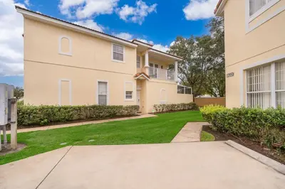 a large house with a lawn in front of it at Epic Arty Retreat near Disney in Kissimmee