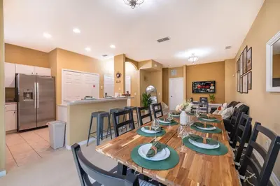 a dining room and kitchen with a table and chairs at Epic Arty Retreat near Disney in Kissimmee