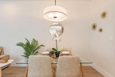 a dining room with a glass table and chairs at Modern Townhouse Heated Pool Disney Orlando 17244 in Orlando