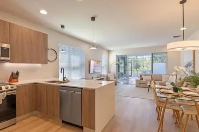 a kitchen and living room with a table and chairs at Modern Townhouse Heated Pool Disney Orlando 17244 in Orlando