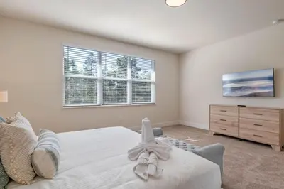 a bedroom with a bed and a dresser and windows at Modern Townhouse Heated Pool Disney Orlando 17244 in Orlando