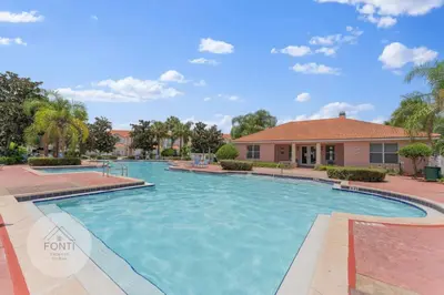 a swimming pool in front of a house at 4875 Resort Townhouse by Disney World Orlando in Kissimmee