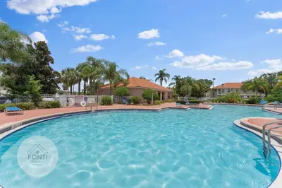 a swimming pool at a resort with palm trees at 4875 Resort Townhouse by Disney World Orlando in Kissimmee