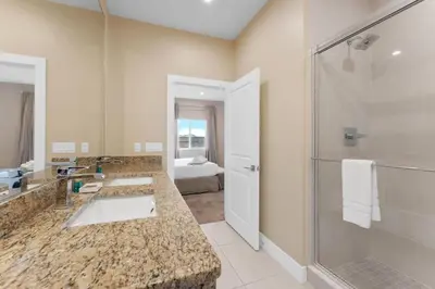 a bathroom with two sinks and a shower at Luxury 4BR Townhouse Next to Disney Orlando 3201 in Orlando