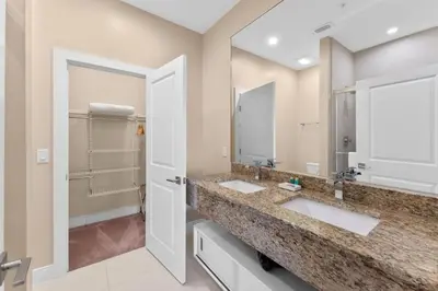 a bathroom with two sinks and a large mirror at Luxury 4BR Townhouse Next to Disney Orlando 3201 in Orlando