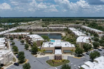an aerial view of an apartment complex with a parking lot at Luxury 4BR Townhouse Next to Disney Orlando 3201 in Orlando