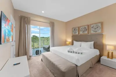 a bedroom with a large white bed and a window at Luxury 4BR Townhouse Next to Disney Orlando 3175 in Orlando