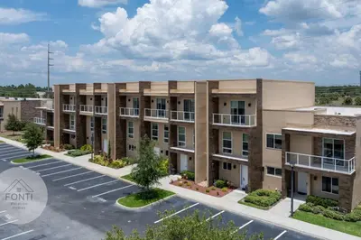 an image of an apartment building with a parking lot at Luxury 4BR Townhouse Next to Disney Orlando 3175 in Orlando