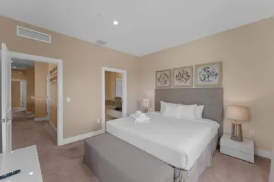a bedroom with a large white bed and a desk at Luxury 4BR Townhouse Next to Disney Orlando 3173 in Orlando