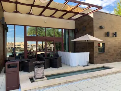 a restaurant with a table and an umbrella at Luxury 4BR Townhouse Next to Disney Orlando 3173 in Orlando