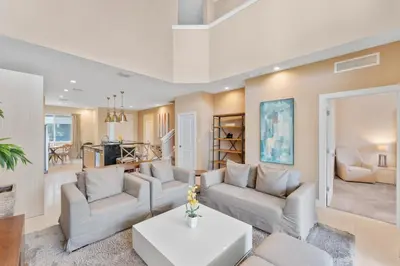 a living room with two couches and a table at Luxury 4BR Townhouse Next to Disney Orlando 3173 in Orlando
