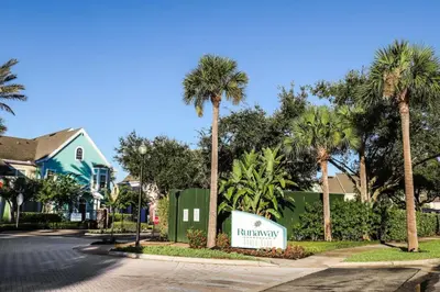 a sign in front of a street with palm trees at Runaway Beach Club Resort Condo Apt Disney 15103 in Kissimmee