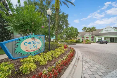 a sign in front of a building with a street at Runaway Beach Club Resort Condo Apt Disney 15103 in Kissimmee
