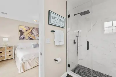 a bathroom with a shower and a bed in a room at 8496 Resort 3BR Condo by Disney World Orlando in Kissimmee