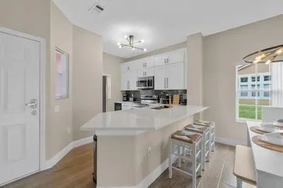 a kitchen with white cabinets and a white counter top at 8496 Resort 3BR Condo by Disney World Orlando in Kissimmee