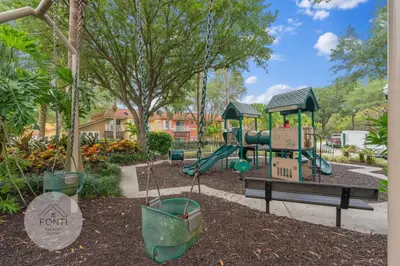 a park with a playground with a slide at 8496 Resort 3BR Condo by Disney World Orlando in Kissimmee
