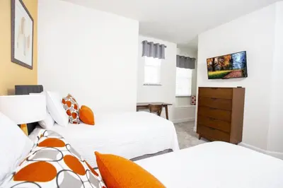 a bedroom with two beds and a tv at Modern Townhouse Heated Pool Disney Orlando 1500R in Orlando