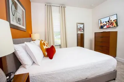 a bedroom with a large white bed and a window at Modern Townhouse Heated Pool Disney Orlando 1500R in Orlando
