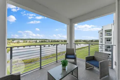a balcony with two chairs and a table at Modern Storey Lake Resort Disney Orlando 3191-307 in Kissimmee