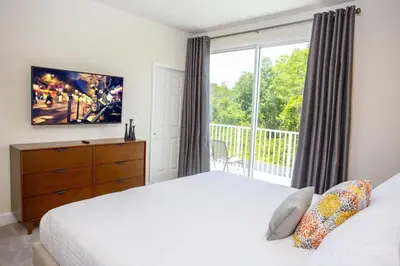 a bedroom with a bed and a large window at Modern Townhouse Heated Pool Disney Orlando 1502R in Orlando