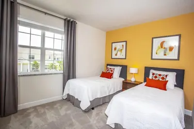two beds in a room with a window at Modern Townhouse Heated Pool Disney Orlando 1502R in Orlando