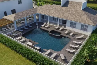 an aerial view of a house with a swimming pool and chairs at Modern Townhouse Heated Pool Disney Orlando 1502R in Orlando
