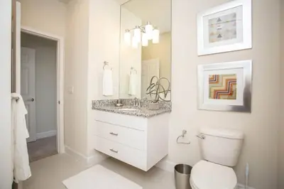 a bathroom with a toilet and a sink and a mirror at Modern Townhouse Heated Pool Disney Orlando 1502R in Orlando