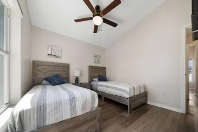 a bedroom with two beds and a ceiling fan at Vacation Oasis Home with Private Pool and Grill 8615 in Kissimmee