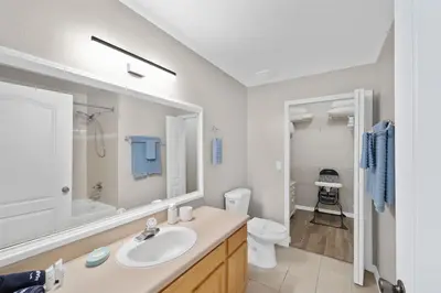 a white bathroom with a sink and a toilet at Runaway Beach Club Resort Condo Apt Disney 6102 in Kissimmee