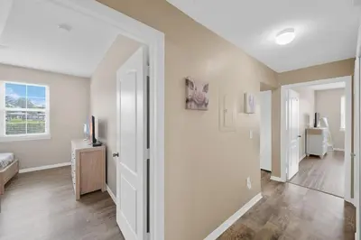a living room with white walls and wooden floors at Runaway Beach Club Resort Condo Apt Disney 6102 in Kissimmee