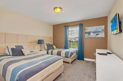 a hotel room with two beds and a window at Storey Lake Resort Townhouse near Disney Orlando 4847 in Kissimmee