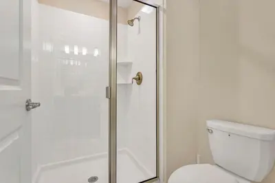 a bathroom with a shower and a white toilet at Storey Lake Resort Townhouse near Disney Orlando 4847 in Kissimmee