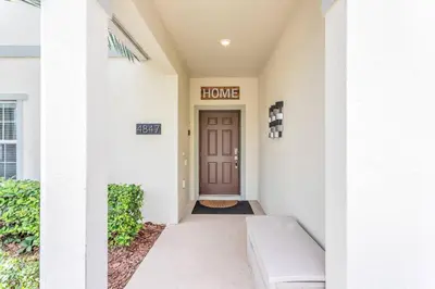 a entrance to a home with a brown door at Storey Lake Resort Townhouse near Disney Orlando 4847 in Kissimmee
