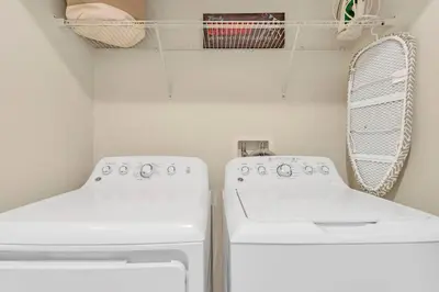 a laundry room with two white washers and a mirror at Storey Lake Resort Townhouse near Disney Orlando 4847 in Kissimmee