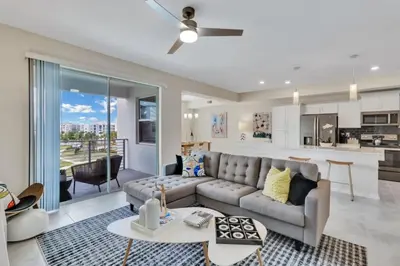 a living room with a couch and a kitchen at Modern Storey Lake Resort Disney Orlando 3150-303 in Kissimmee