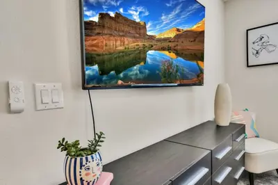 a living room with a tv hanging on the wall at Modern Storey Lake Resort Disney Orlando 3150-303 in Kissimmee
