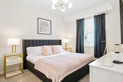 a bedroom with a large bed and a desk at Modern Storey Lake Resort Disney Orlando 3171-206 in Kissimmee