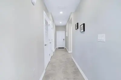 a hallway with white walls and a tile floor at Modern Storey Lake Resort Disney Orlando 3171-107 in Kissimmee