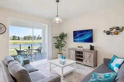 a living room with a couch and a table at Modern Storey Lake Resort Disney Orlando 3161-107 in Kissimmee
