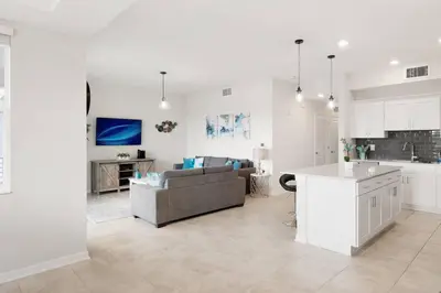 a kitchen and living room with a couch and a table at Modern Storey Lake Resort Disney Orlando 3161-107 in Kissimmee
