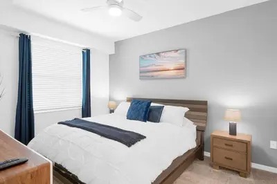 a bedroom with a large bed and a window at Modern Storey Lake Resort Disney Orlando 3191-103 in Kissimmee