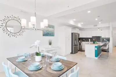 a kitchen and dining room with a table and chairs at Modern Storey Lake Resort Disney Orlando 3191-103 in Kissimmee