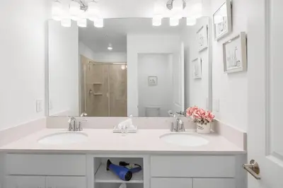 a bathroom with two sinks and a large mirror at Modern Storey Lake Resort Disney Orlando 3191-106 in Kissimmee