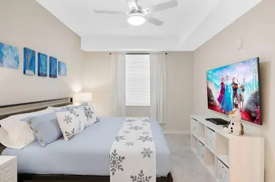 a white bedroom with a bed and a ceiling fan at Modern Boho Storey Lake Resort Disney 3150-106 in Kissimmee