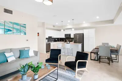 a living room and kitchen with a couch and a table at Modern Boho Storey Lake Resort Disney 3150-106 in Kissimmee