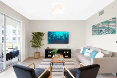 a living room with a couch and a table at Modern Boho Storey Lake Resort Disney 3150-106 in Kissimmee