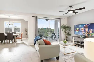 a living room with a ceiling fan and a dining room at Modern Storey Lake Resort Disney Orlando 4751-306 in Kissimmee