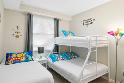 a bedroom with two bunk beds and a window at Modern Storey Lake Resort Disney Orlando 4751-306 in Kissimmee
