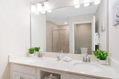 a bathroom with two sinks and a large mirror at Modern Storey Lake Resort Disney Orlando 4751-306 in Kissimmee
