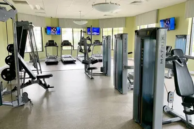 a gym with several treadmills and tread machines at Modern Storey Lake Resort Disney Orlando 4751-306 in Kissimmee